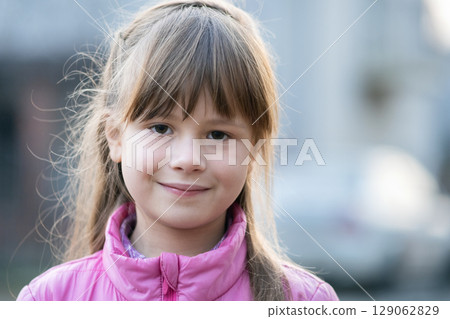Portrait of happy child girl in warm clothes in autumn outdoors. Portrait of happy child girl in warm clothes in autumn outdoors. 129062829