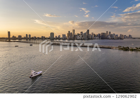Miami, Florida. Biscayne Bay harbor near Virginia Key with yachts and sailboats at sunset. Urban skyline with high-rise buildings in downtown Miami, Florida. Biscayne Bay harbor near Virginia Key with yachts and sailboats at sunset. Urban skyline with high-rise buildings in downtown 129062902