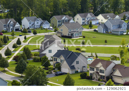 Low-density two story private homes in rural residential suburbs outside of Rochester, New York. Upscale suburban houses with large lot size and green grassy lawns in summer season 129062921