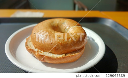 Freshly Baked Bagel Served on a White Plate Freshly Baked Bagel Served on a White Plate 129063889