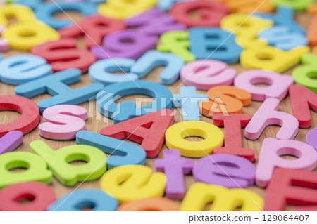 Colorful alphabet scattered background 129064407