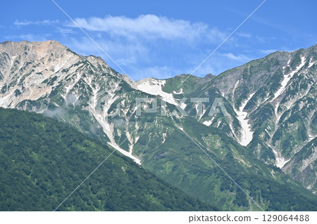 Summer sky and remaining snow on the Hakuba mountain range / Nagano Prefecture Summer sky and remaining snow on the Hakuba mountain range / Nagano Prefecture 129064488