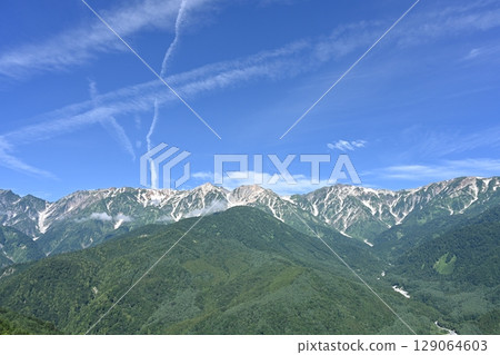 Summer sky and remaining snow on the Hakuba Sanzan mountains / Nagano Prefecture 129064603