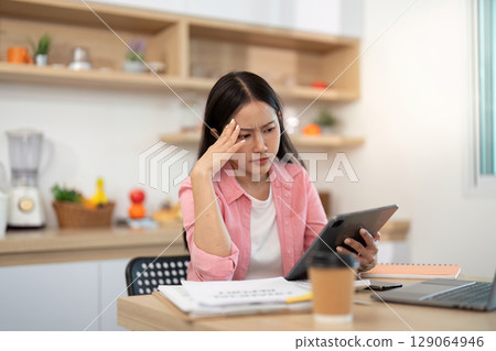 Work from Home: Stressed woman dealing with work challenges 129064946