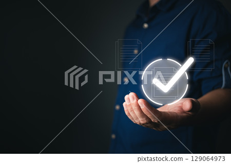 A person holds as virtual document icons with checkmarks appear, representing quality assurance, client focused services, and seamless document management in a digital workflow. 129064973
