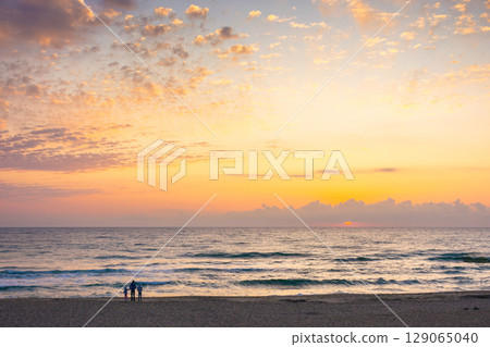 sunrise at the sea in summer with sun and cloudscape above horizon. calm travel background at dawn. dramatic weather sunrise at the sea in summer with sun and cloudscape above horizon. calm travel background at dawn. dramatic weather 129065040