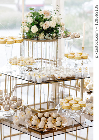 Delicious desserts decorating a wedding reception table 129065138