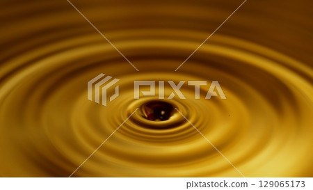 Freeze Motion of Splashing Whiskey or Cider Drop. Super Macro Shot, Extreme Close-up. Freeze Motion of Splashing Whiskey or Cider Drop. Super Macro Shot, Extreme Close-up. 129065173