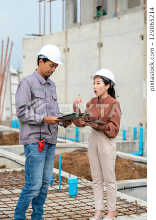 Engineers are having a construction planning meeting at the job site. Engineers are having a construction planning meeting at the job site. 129065214