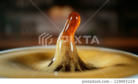 Freeze Motion Detail Shot of Coffee Drop Falling into Fresh Espresso Freeze Motion Detail Shot of Coffee Drop Falling into Fresh Espresso 129065229