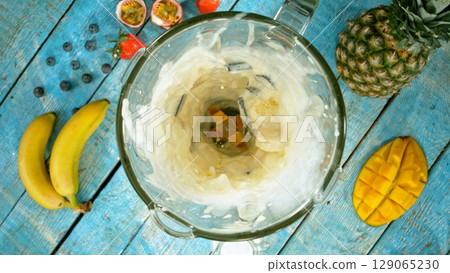 Mixing pieces of fruits in blender, top view. 129065230