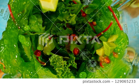 Mixing pieces of fruits and vegetable in blender, top view. 129065233