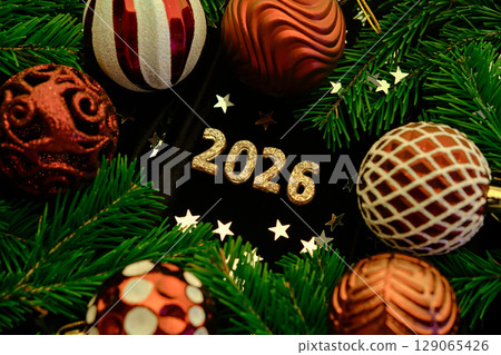 New Year 2026 dark background. Number of the coming year in Christmas decoration. 129065426