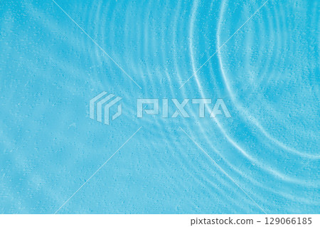 drops on water with circles on a blue background drops on water with circles on a blue background 129066185