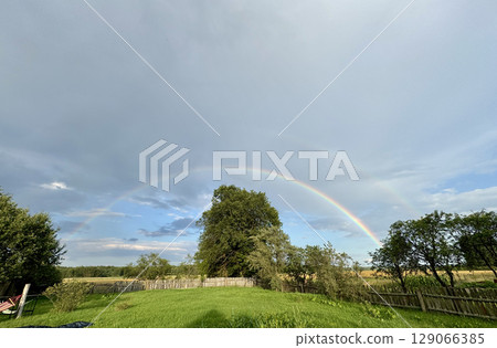 Double rainbow in the blue sky. Rural landscape. Double rainbow in the blue sky. Rural landscape. 129066385
