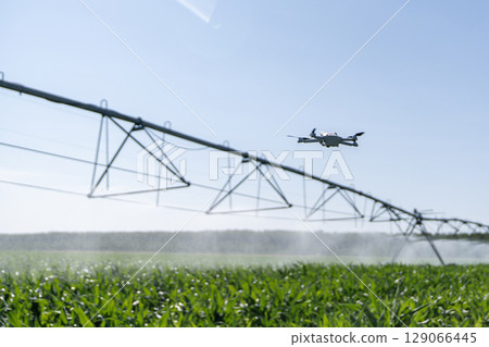 Drone controls pivot irrigation system on an agricultural field Drone controls pivot irrigation system on an agricultural field 129066445