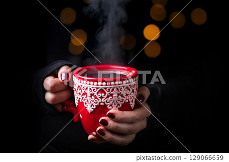 Hands holding red mug Hands holding red mug 129066659