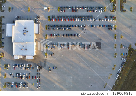 Large parking lot of local dealer with many brand new cars parked for sale. Development of american automotive industry and distribution of manufactured vehicles concept 129066813