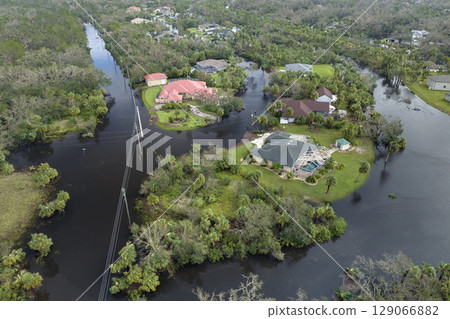 Heavy flood with high water surrounding residential houses after hurricane rainfall in Florida residential area. Consequences of natural disaster Heavy flood with high water surrounding residential houses after hurricane rainfall in Florida residential area. Consequences of natural disaster 129066882