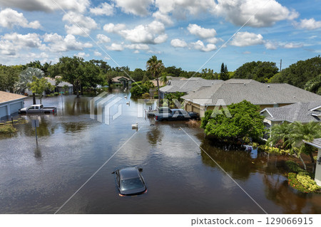 Flooded road with sunken car in surrounded with water Florida residential area. Consequences of hurricane Debby natural disaster 129066915