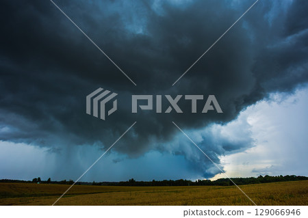 Dark supercell storm clouds with massive rain shaft. 129066946