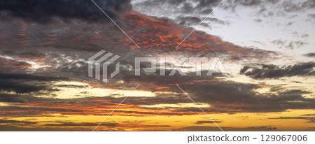 Evening sunset sky with colorful clouds. Panoramic skyscape 129067006