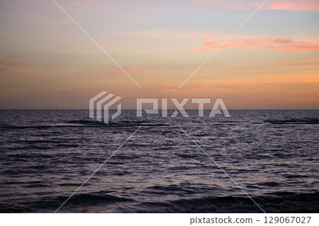 Dramatic red ocean waves at sunset with soft evening sea dark water 129067027