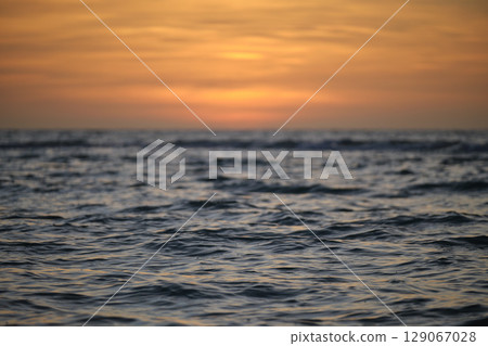 Dramatic red ocean waves at sunset with soft evening sea dark water 129067028