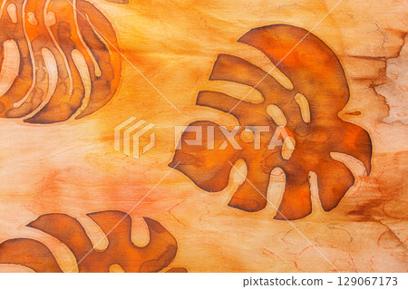 abstract pattern on silk fabric texture in yellow and brown tones 129067173