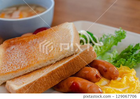 Western-style breakfast plate with toast, sausage, and scrambled eggs 129067706
