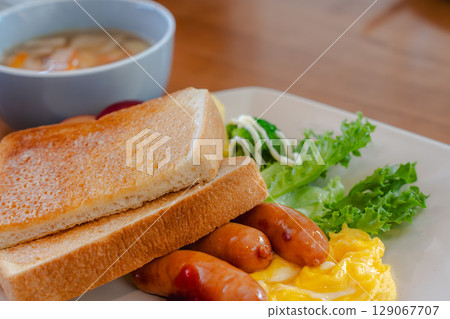 Western-style breakfast plate with toast, sausage, and scrambled eggs 129067707