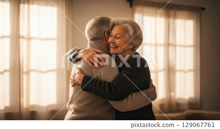 Elderly Couple Embracing in a Cozy Living Room - AI generated 129067761