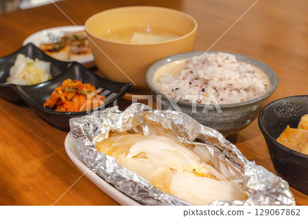 A home-style Japanese dinner set featuring foil-wrapped food, multigrain rice, and miso soup A home-style Japanese dinner set featuring foil-wrapped food, multigrain rice, and miso soup 129067862