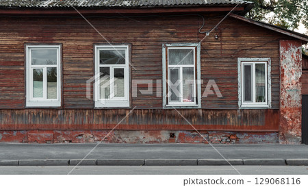 Old Wooden House with White Framed Windows 129068116