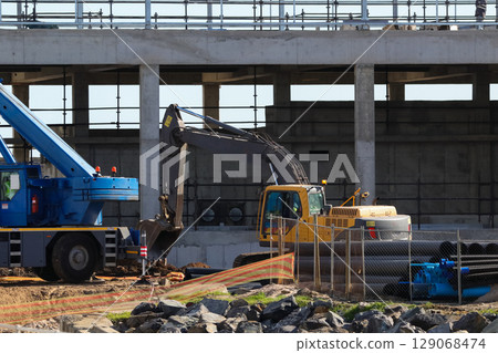 Heavy Machinery Working On Building Construction Site 129068474