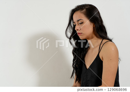 Young latin woman feeling sad and showing negative emotions Young latin woman feeling sad and showing negative emotions 129068696
