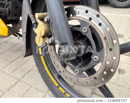 Exploring the intricate details of a motorcycle brake system on a sunny day Exploring the intricate details of a motorcycle brake system on a sunny day 129068747