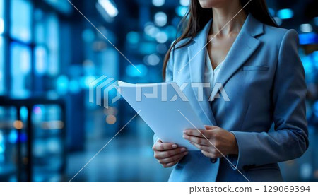 Business, people and technology concept - close up of businesswoman with papers in office 129069394