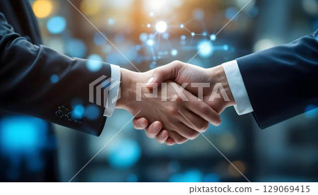 Business handshake with double exposure of network hologram. Concept of partnership and teamwork 129069415
