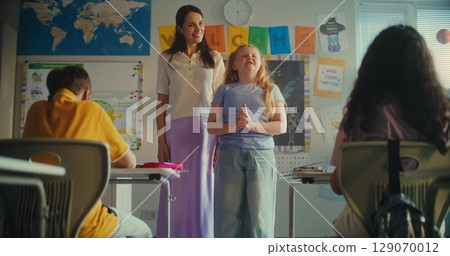 Primary School Girl Showcasing Knowledge of Renewable Energy Resources in Front of Class 129070012