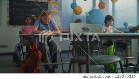 Sad School Girl Suffering from School Bullying, Peer Harassment from Classmates 129070014