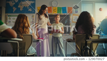 Female Teacher Presenting Elementary School Student. Smart Girl Giving Presentation on Ecology 129070027
