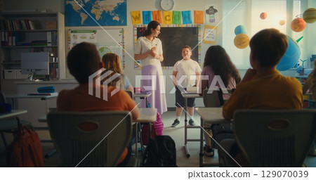 Elementary School Student Speaking about Energy Sources in Front of Classroom Elementary School Student Speaking about Energy Sources in Front of Classroom 129070039