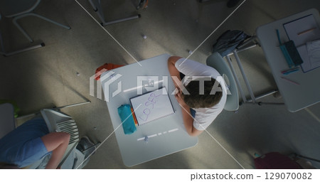 Classmates Bullying Stressed Elementary School Boy Sitting at Desk and Crying Classmates Bullying Stressed Elementary School Boy Sitting at Desk and Crying 129070082