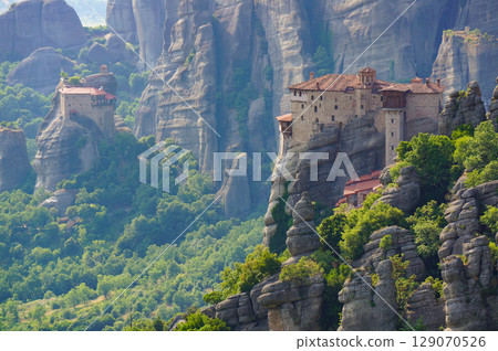 A view of the monastery standing on a strange rock formation in the mountains A view of the monastery standing on a strange rock formation in the mountains 129070526