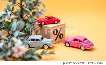 A whimsical arrangement of wooden toy cars and a percentage symbol on a yellow canvas, illustrating insurance discounts for family-focused products 129071502