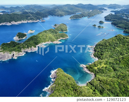 Aerial view of the blue sea and islands taken by drone from Yoneyama Observatory on Nakadori Island in the Goto Islands, Nagasaki Prefecture Aerial view of the blue sea and islands taken by drone from Yoneyama Observatory on Nakadori Island in the Goto Islands, Nagasaki Prefecture 129072123