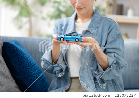 A woman with a car model A woman with a car model 129072227