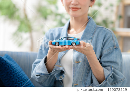 A woman with a car model A woman with a car model 129072229