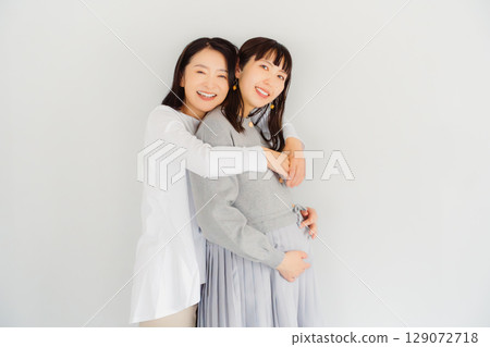 A happy mother and her daughter nearing the end of her pregnancy A happy mother and her daughter nearing the end of her pregnancy 129072718